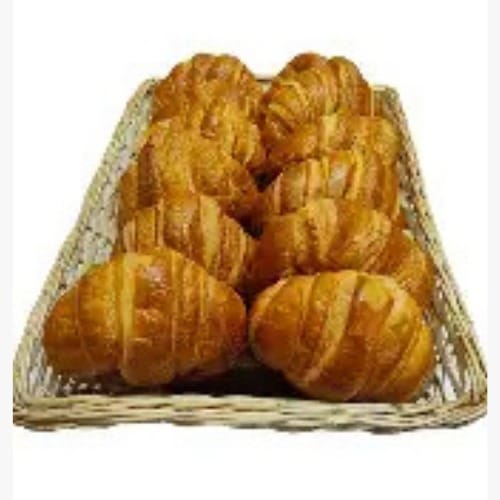 CROISSANT - Costa Rica Food Services l Food Services Basket of freshly baked croissants with golden, flaky layers in a wicker basket.